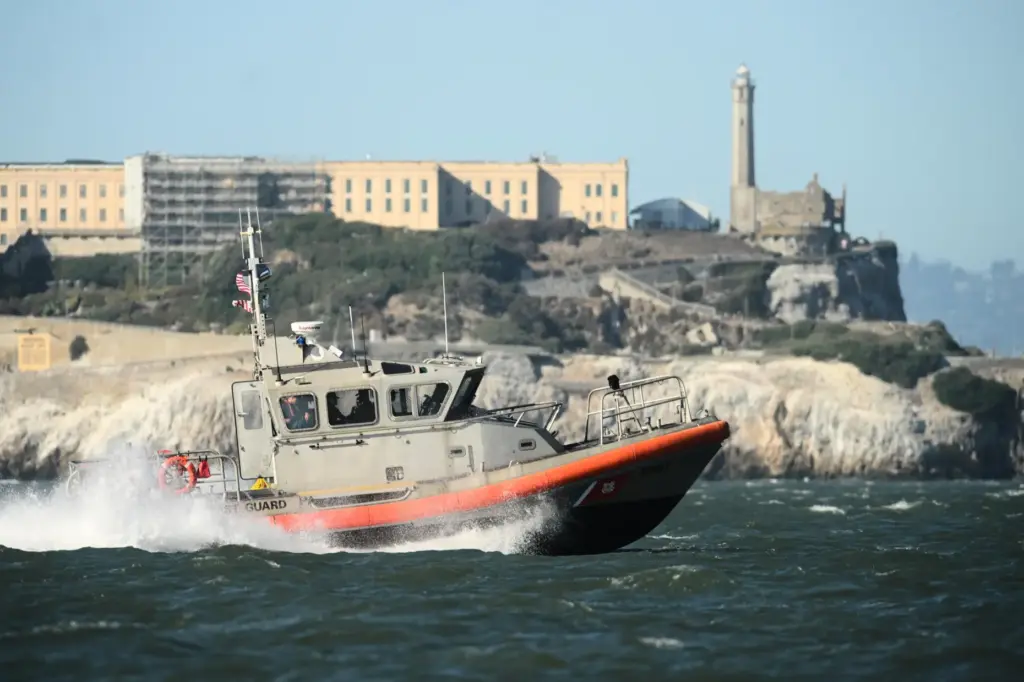 A U.S. Coast Guard crew goes past Alcatraz Island near...
