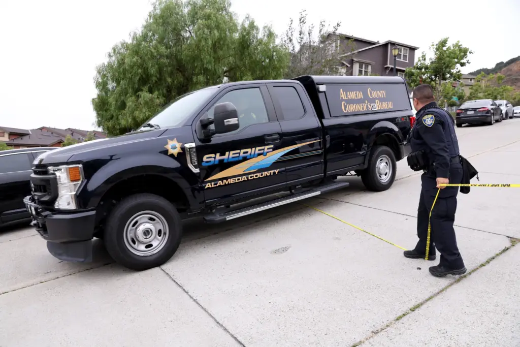 Sheriffâs deputies from the Alameda County Coronerâs Bureau remove a...