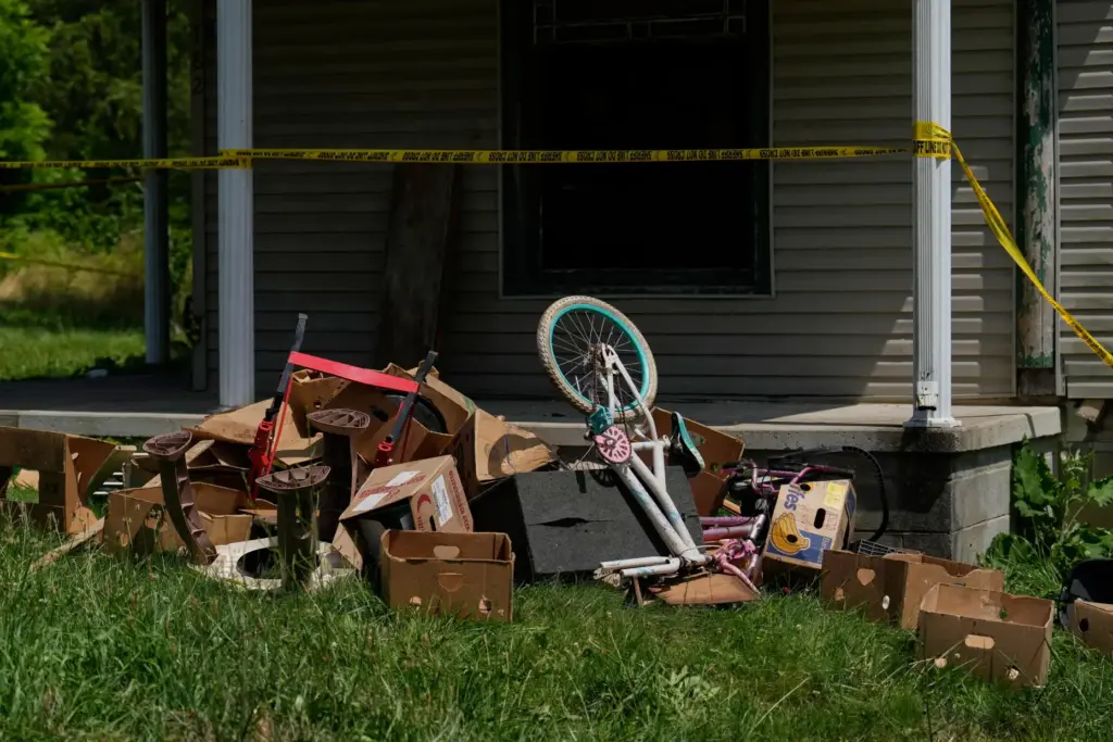 Police tape and debris are seen at a home where...