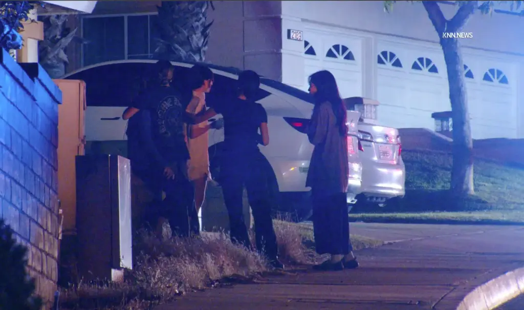 Family members gather outside home on Monteverde Drive, in Chino...