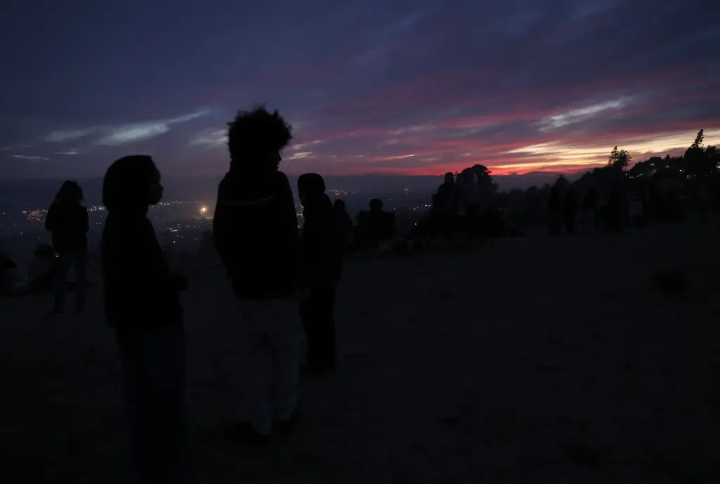 Local residents view illegal fireworks from a hillside as the...