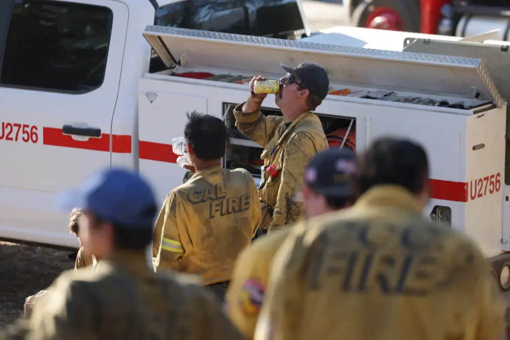 Firefighters from the California Conservation Corps and Cal FireÂ rest and...