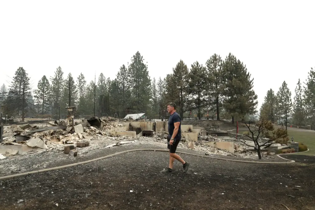 Dan Munson walks in the backyard of his home on...