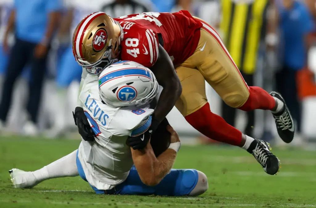 San Francisco 49ers' Tatum Bethune (48) sacks Tennessee Titans quarterback...
