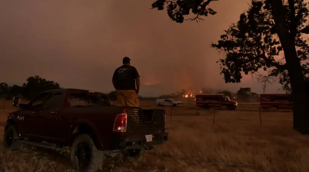 An evacuee watches as the Pickett Fire rolls in to...
