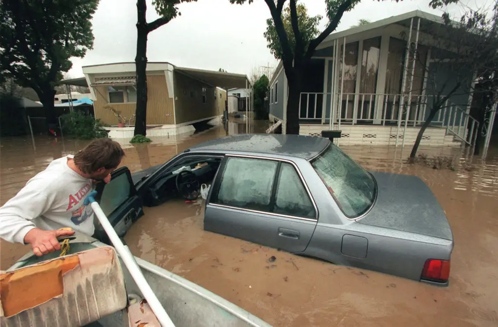 After flooding from an El Nino storm, Marcel Zuber checks...