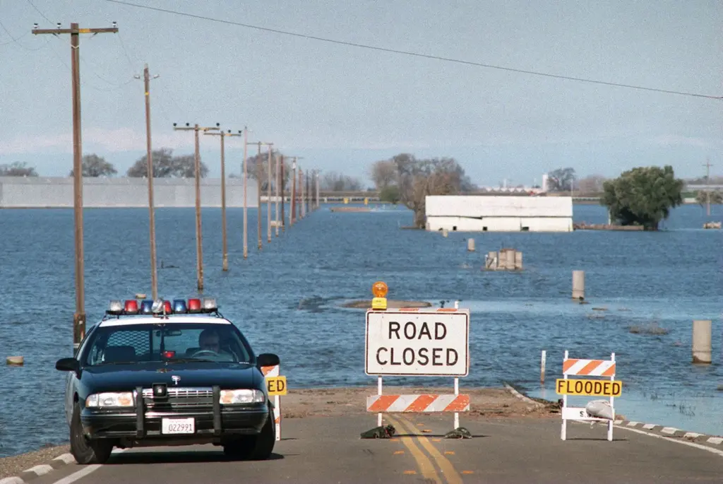 A CHP officer is parked on a closed road off...