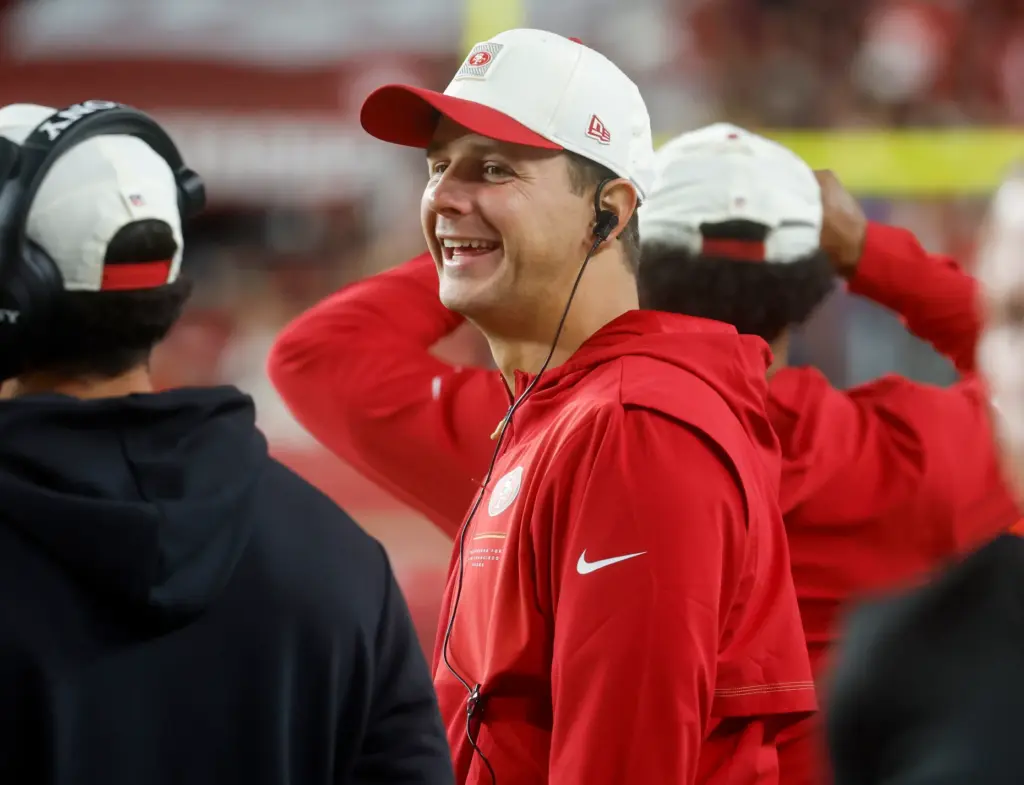 San Francisco 49ers' Brock Purdy (13) smiles on the sidelines...