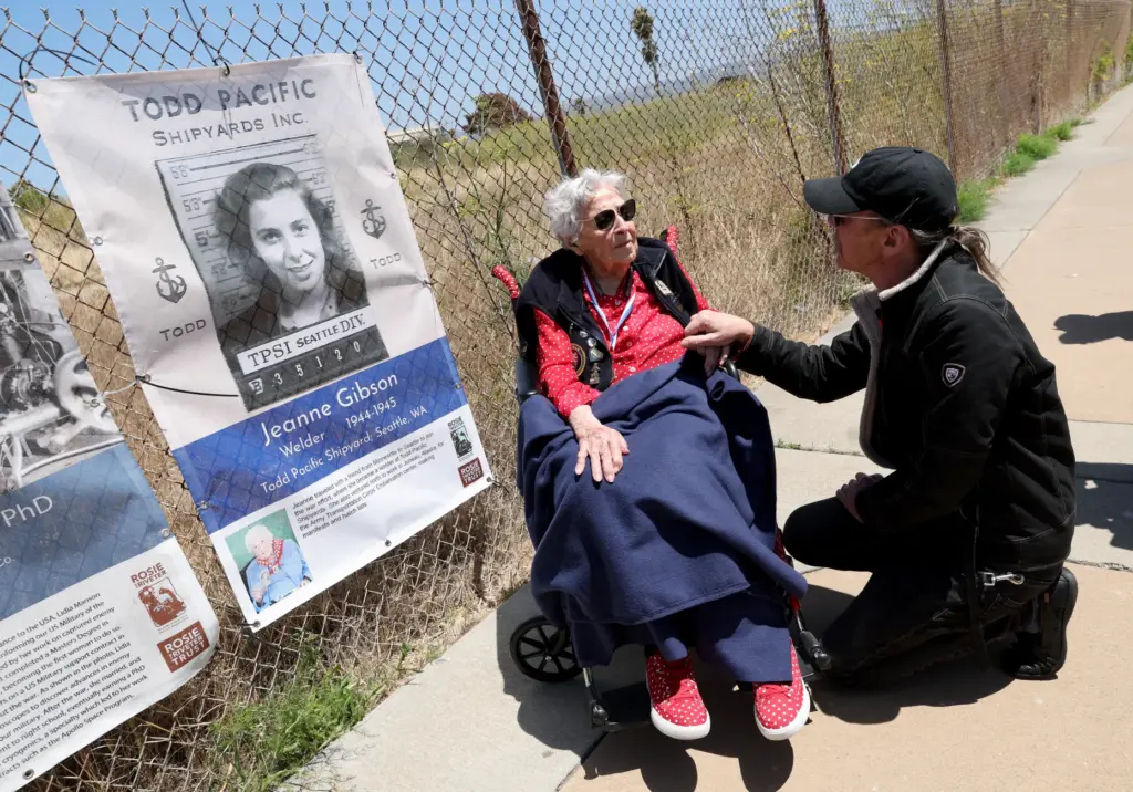 Thayer Walker, of San Francisco, talks with Rosie the Riveter...