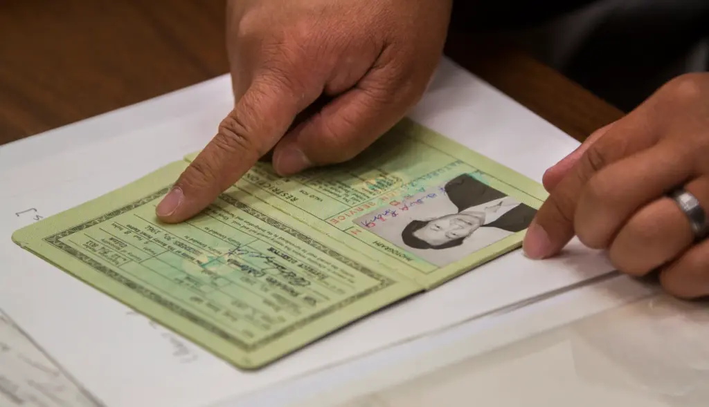 Gilbert Lee looks at a visa record of his grandfather...