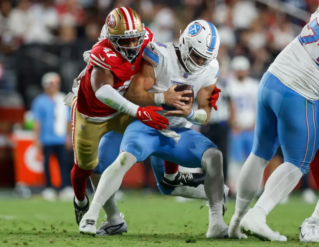 San Francisco 49ers' Josiah Deguara (47) sacks Tennessee Titans quarterback...
