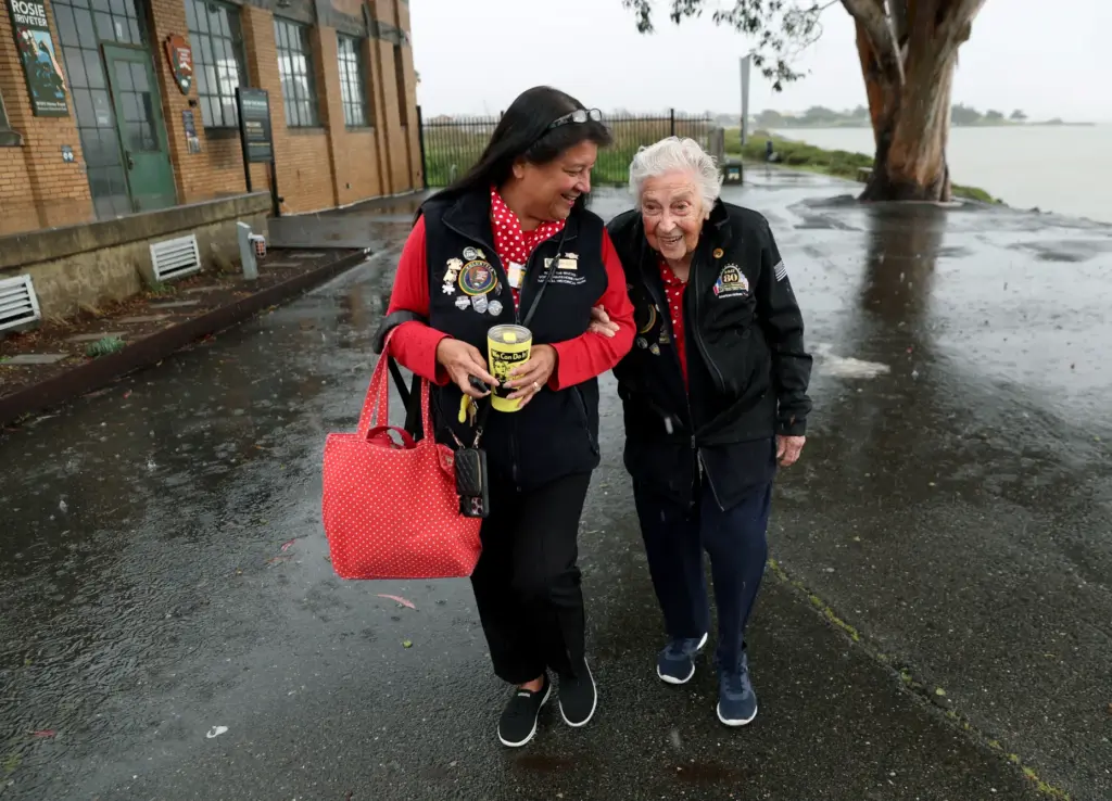 Volunteer Tammy Brumley, known as the âRosie Wrangler,â left, escorts...