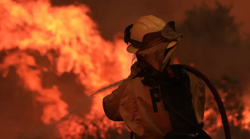 Shelby Buchmann with the Graton Fire Protection District cools the...