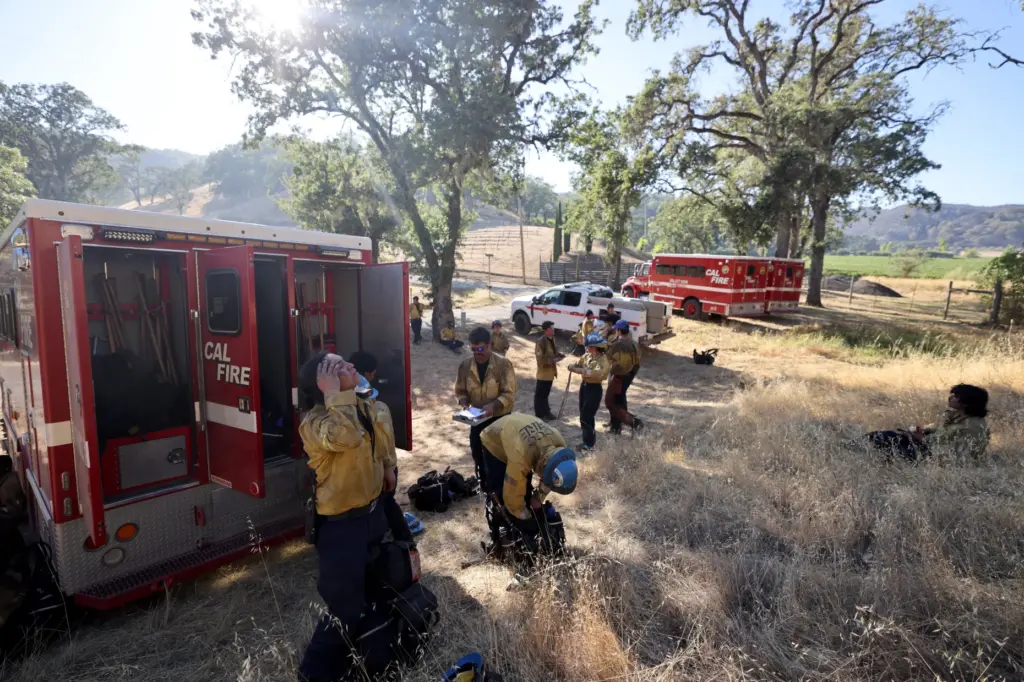 Firefighters from the California Conservation Corps overseen by CalÂ FireÂ rest and...