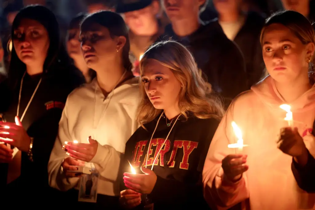 Students attend a vigil for seniors Dominic Ferrari, and Caden...
