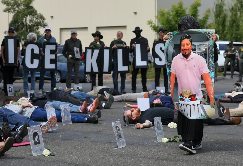 A protester carries a photograph of Lorenzo Salgado, who recently...