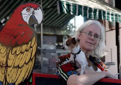 Lissa Shoun, owner of Andy's Pet Shop, stands next to...