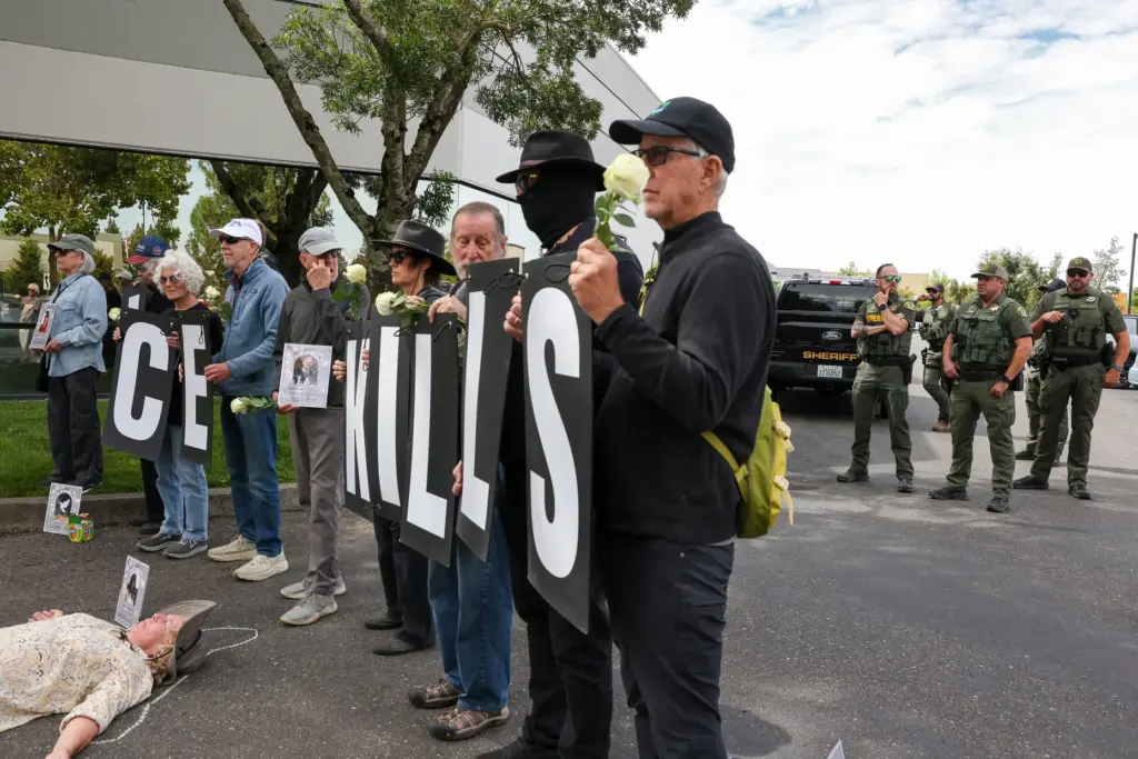 Sonoma County Sheriffs Officers gather behind protesters during Sonoma County...