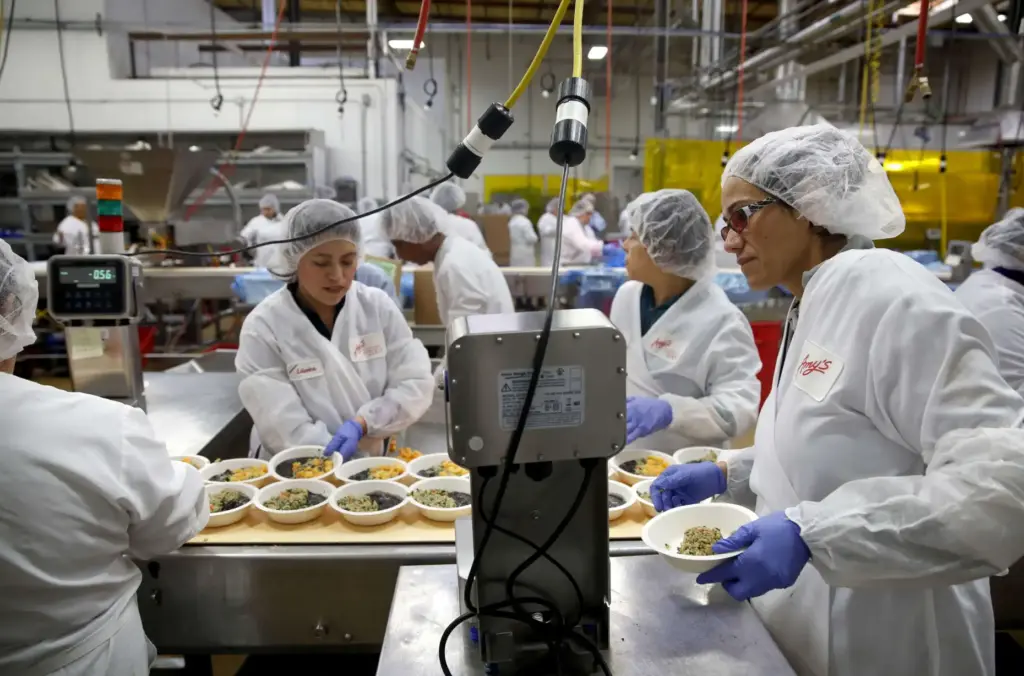 Amy’s Kitchen team leader Gricelda Barajas Barragan, right, manages a...
