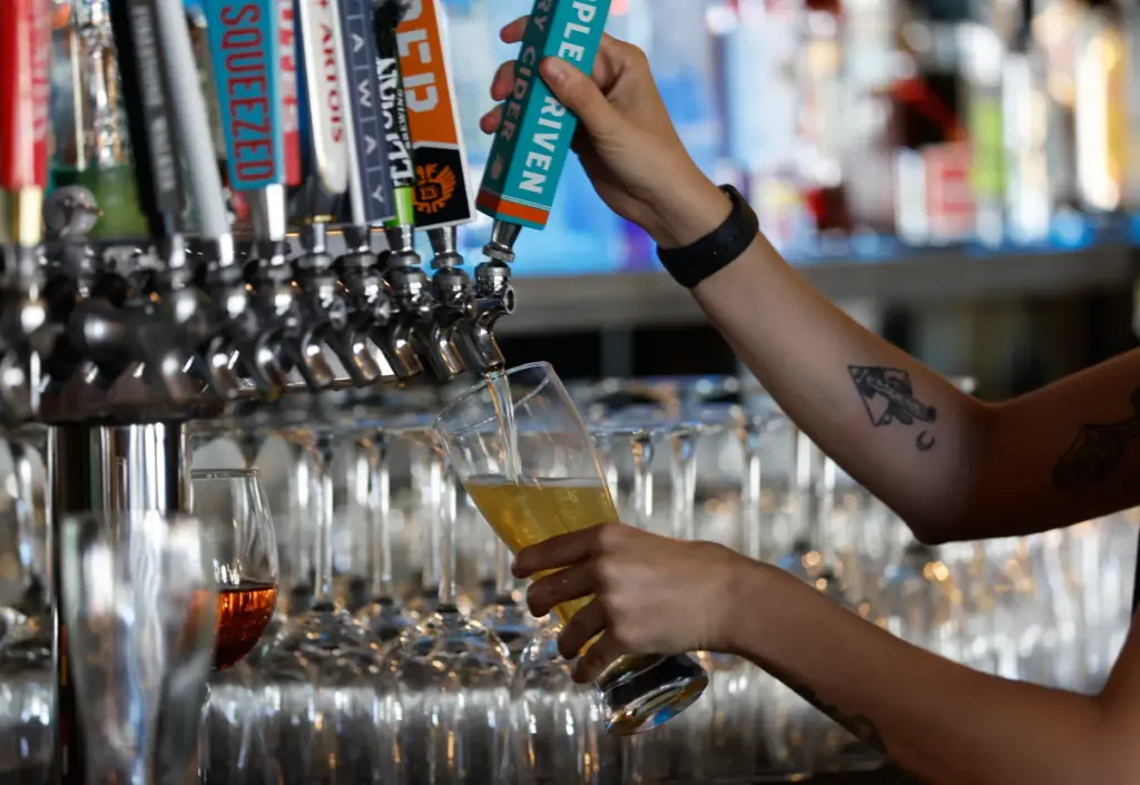 McKenna Jaworski, bartender, pours a beer at Zac's Bar &...