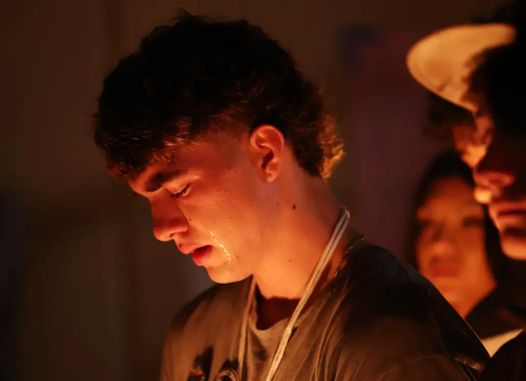 A student sheds tears at a vigil for seniors Dominic...