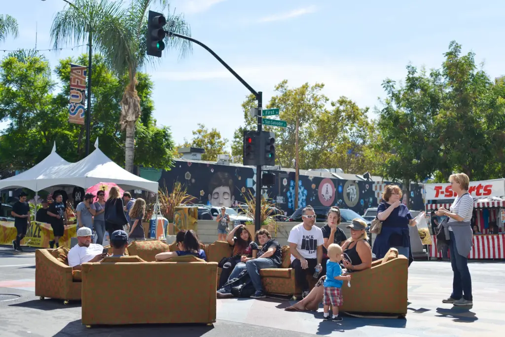 People hang out on sofas during the SoFA Street Fair...