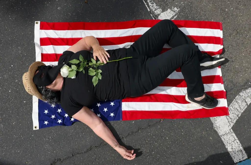 A protester, who declined to provide their name, participates in...