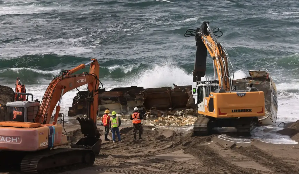 Personnel from Parker Diving of Sausalito salvage what is left...