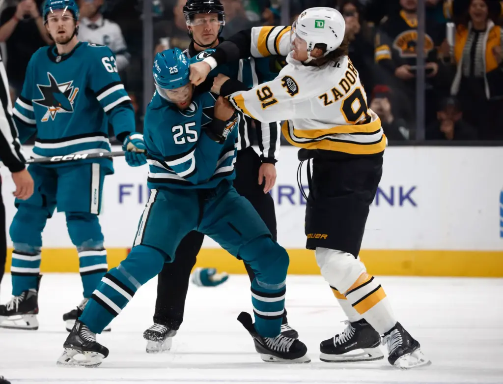 San Jose Sharks' Darnell Nurse (25) fights with Boston Bruins'...
