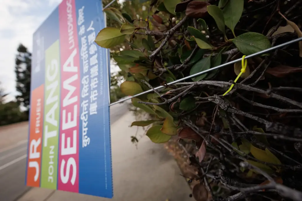 A zip tie secures an allegedly tampered sign of Cupertino...