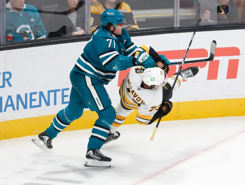 San Jose Sharks' Macklin Celebrini (71) scuffles with Boston Bruins'...