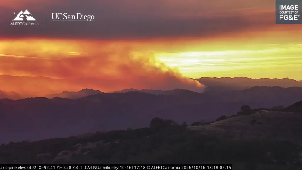 A large prescribed burn produces a visible column of smoke...