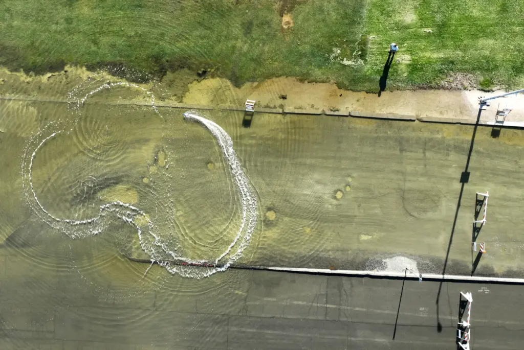A man operates a remote control boat in this drone...