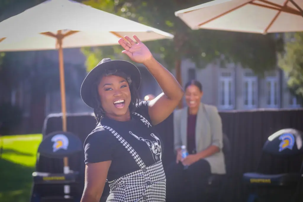 Tianna Madison, two-time Olympian with three gold medals, waves to...
