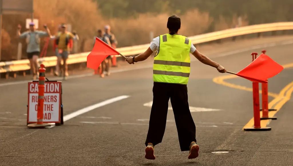 A volunteer encourages competitor during the “SufferFest”100-mile run, part of...